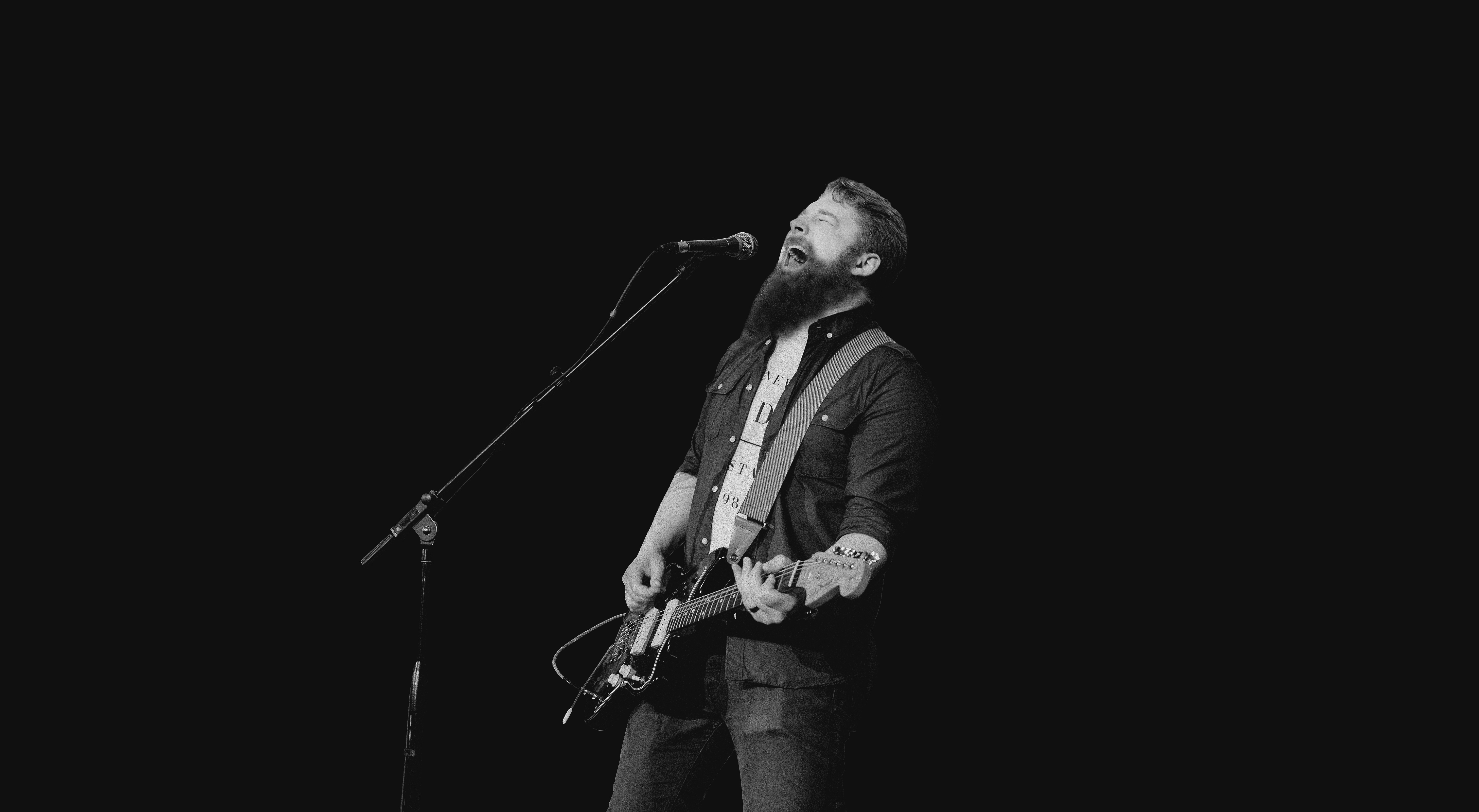 An old, edited photo of me playing guitar and yelling into a microphone.